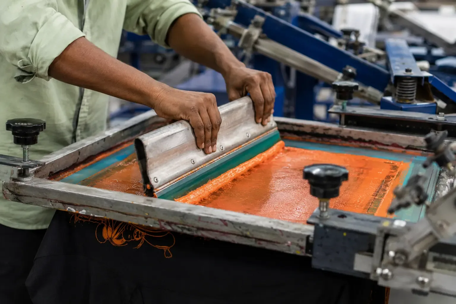 Screen printing process on cotton T-shirts in a garment manufacturing factory